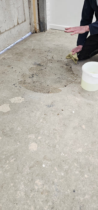 Coo-Var Oil Remover shown before use on an oil-stained garage floor.