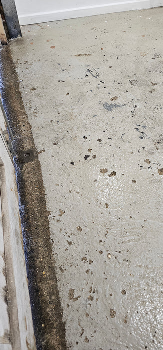 Coo-Var Oil Remover shown on a cleaned concrete garage floor.